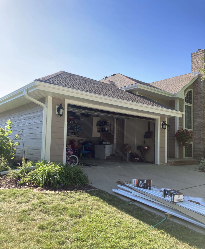 Schmidt installs white gutters on a Waukesha home